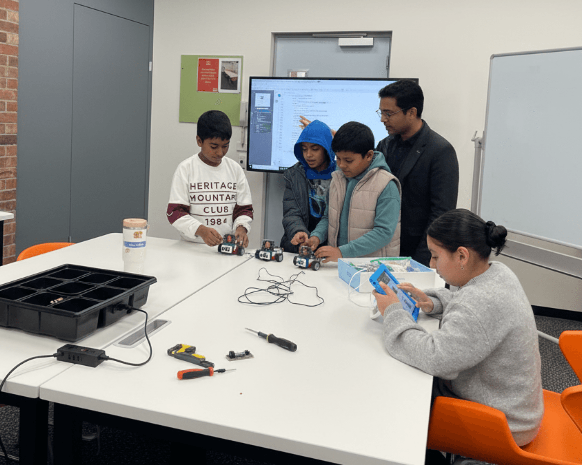 Students troubleshooting and fixing their rovers